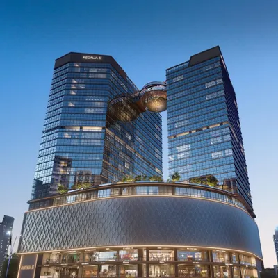 A view of the award-winning Nakshatra Regalia II in GIFT City. This 120-meter tall mixed-use development integrates premium offices, retail, and fine dining, all connected by a distinctive central globe structure.