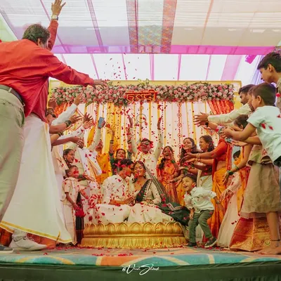 The Haldi ceremony at its most chaotic and joyful, with family and friends showering the couple with flower petals.