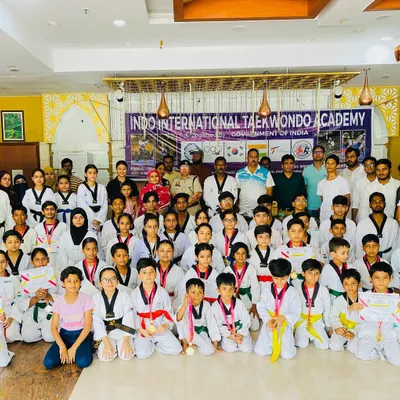 I am incredibly proud of my students' achievements. This photo captures a medal and belt distribution ceremony for the Indo International Taekwondo Academy, an event honored by the presence of the ACP of the Crimes Against Women Cell.