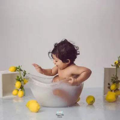 Simple, clean, and so much fun. This lemon-themed milk bath uses a minimalist setup to keep all the focus on the baby's adorable splashes and expressions.