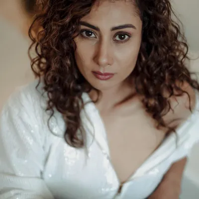 This high-angle shot creates a direct and intimate connection with the viewer. The focus is entirely on the model's expressive eyes and features.