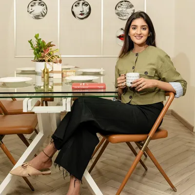 A portrait of an interior designer for a feature in Livingetc India magazine. The subject is captured in her own element, seated at her dining table, which adds a layer of authenticity to her professional story.