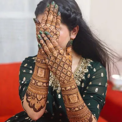 A classic full-hand bridal design with a heavy 'jaal' or net pattern. This style is timeless and gives a very rich, filled-in look that brides love.