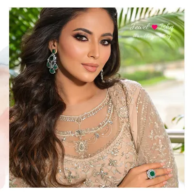 Reception ready. This look is all about sophisticated glamour, pairing a neutral-toned outfit with bold statement emerald and diamond earrings and a matching ring. It's a powerful yet elegant choice for a modern bride.