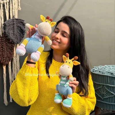 Here I am with our beloved giraffe duo, Tinu and Minu. These were some of the first amigurumi toys we designed, and they hold a special place in our hearts. Their lanky legs and sweet faces make them a favorite among kids.