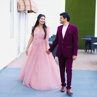 A perfect couple's look for a reception or engagement party. This flowing baby pink gown with delicate embroidery on the bodice pairs beautifully with a sharp wine-coloured tuxedo. Both are available to rent for your special day.