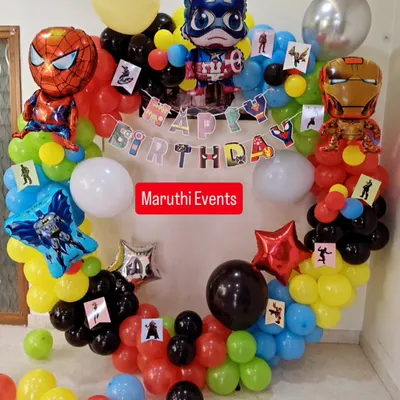 A full superhero team-up for a birthday bash. This circular balloon arch is decorated with foil balloons of Spiderman, Captain America, and Iron Man, creating an exciting centerpiece for the party.
