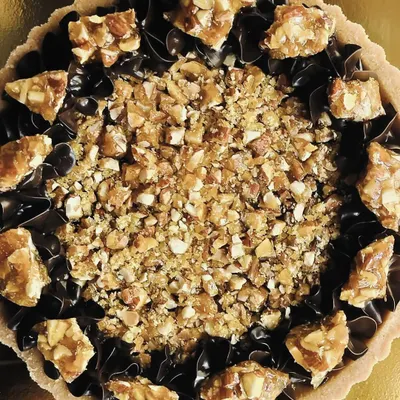 This is pure decadence. My dark chocolate and almond praline tart features a rich chocolate filling, piped chocolate swirls, and a generous topping of crunchy almond praline.