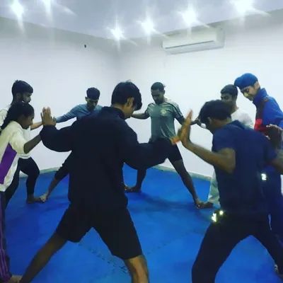 Flexibility is crucial for executing advanced techniques and preventing injuries. Here, our team engages in a group stretching exercise to improve mobility.