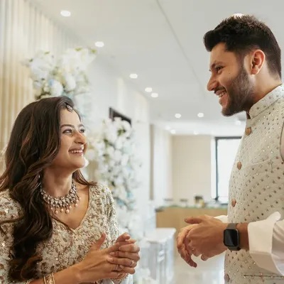 The moment it begins. We love capturing the raw, candid reactions during an engagement, like this shared laugh between Aditi and Rushang.