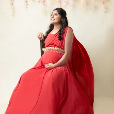 Feel like the queen you are in a flowing red gown. This dreamy maternity portrait uses soft light and a floral backdrop to highlight your radiant glow.