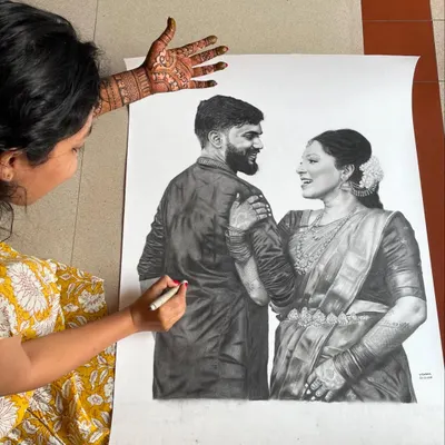Here you can see me working on a large-scale pencil portrait, a skill that I bring to every mehendi design. My ability to draw faces and figures on paper ensures I can create detailed and accurate portraits for you in henna.