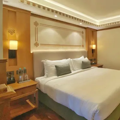 A look at the master bed in our Gangtok project for ITC hotels. We used soft, indirect lighting in the ceiling cove and custom wall paneling with traditional motifs to create a restful and luxurious ambiance.