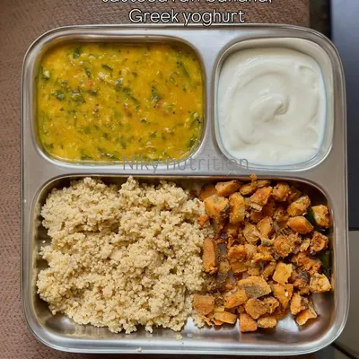 A perfectly balanced vegetarian meal featuring foxtail millet, dal methi (lentil and fenugreek curry), sautéed raw banana, and a side of Greek yogurt for a protein boost.