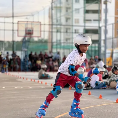 A young skater shows great form and concentration during our in-house skating competition on the multi-purpose court.