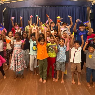 The pure joy of a completed project is captured in this photo of our students holding up their origami creations. Our group craft sessions are filled with energy, collaboration, and lots of happy faces.