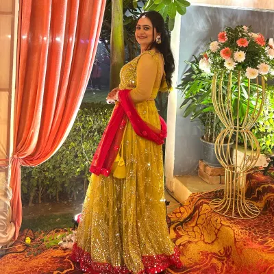 A perfect Haldi or Mehendi look. This client is wearing a bright yellow lehenga with a contrasting pink dupatta, paired with glowing makeup for her pre-wedding event.