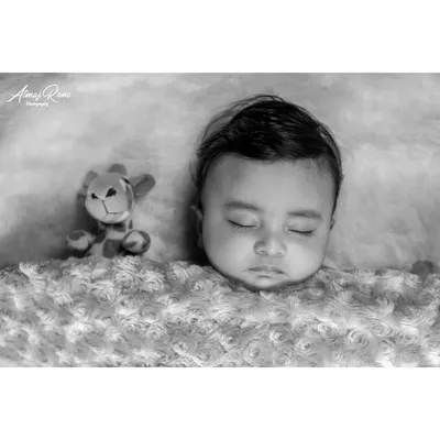 There is a timeless elegance to a black and white portrait. This style emphasizes the soft textures and peaceful expression of a sleeping baby, creating a beautiful piece of art that focuses purely on your little one.