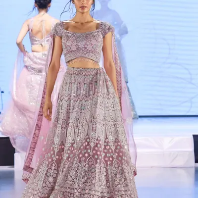Capturing the elegance of a bridal lehenga on the runway at the "Shaadi by Marriott Bonvoy" event. My focus is on getting a clean, sharp image that showcases the outfit's intricate details and flow.