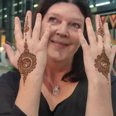 A happy client at a corporate event showing off her matching mandala designs. I love bringing the joy of mehendi to parties and seeing smiles like this.