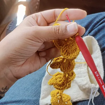 I always carry my crochet kit when I travel. I made this little yellow flower during a cab ride. My little bag of yarn turns any moment into a creative one.