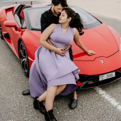 A high-fashion moment in the Dubai desert. This pre-wedding shoot combines the thrill of a luxury sports car with the romance of the open road.