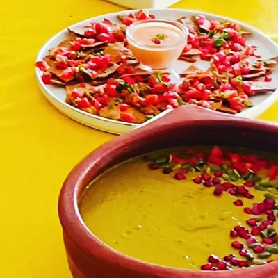 A healthy party platter featuring my homemade, plant-based baked nachos and a summer cold soup served with a vegan mayo dip. It's vibrant, delicious, and completely guilt-free.