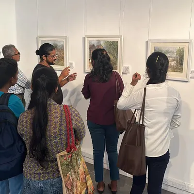 Visitors at my international exhibition in Colombo, looking closely at my watercolor paintings.