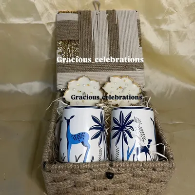 A beautiful Diwali hamper to share the joy of the festival. This jute box contains two elegant deer-printed mugs and matching coasters, perfect for gifting with love.
