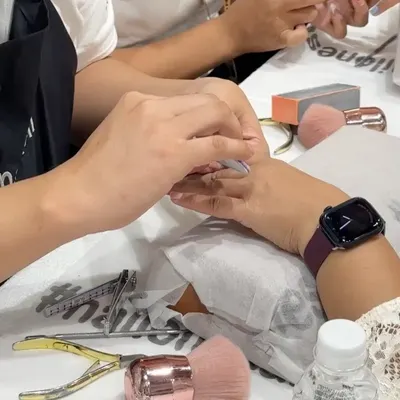 A close-up of a student practicing nail filing and shaping during a hands-on training session. Proper preparation of the nail bed is a fundamental skill we emphasize for long-lasting and beautiful nail extensions.