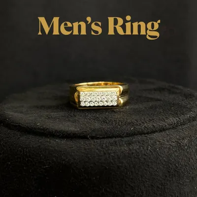 A classic men's ring design featuring two clean rows of pavé-set diamonds on a rectangular gold face. The polished band and sharp lines make it a powerful yet refined statement piece, seen here on a display stand.