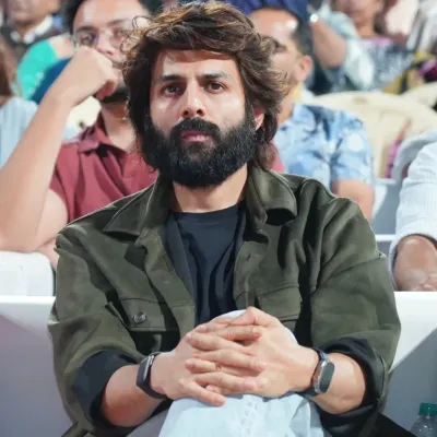 A candid shot of actor Kartik Aaryan in the audience at the D Y Patil University convocation. Our event photographers excel at capturing natural, unposed moments of key attendees and guests.
