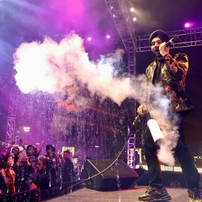 We bring star power and excitement to your event. Here, singer Gurdeep Mehndi electrifies the crowd with a CO2 cannon during a New Year's Eve concert, a moment of pure energy that we planned and executed.
