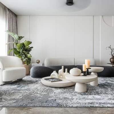 When designing a living room, our focus is on creating a space that’s functional, inviting, and a true reflection of your personal style. Here, we used distinct areas for different activities, using sculptural furniture and a textured rug to define the zones.