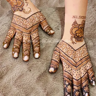 A beautiful and popular back-hand design. This style features a modern V-shape pattern that elongates the hand, combined with delicate floral work and a unique wrist cuff element.