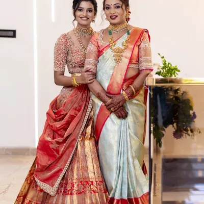 A heartwarming portrait of a mother and daughter for their house warming ceremony, both looking graceful and elegant.