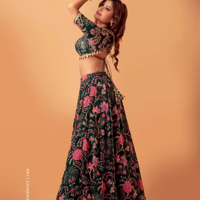This custom green floral lehenga is perfect for a daytime wedding or a garden party. The blouse features a delicate back tie and tassels, and the full skirt has a beautiful flair for that perfect twirl.