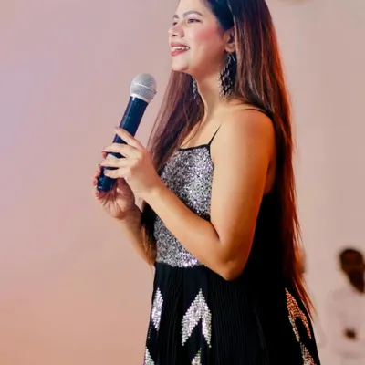 A candid shot on stage, sharing a smile. I'm always in my happy place when I have a mic in my hand.