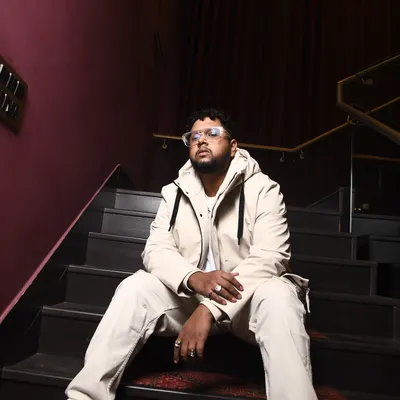 This is a shot from a recent photoshoot. The all-white fit on the stairs, it's a whole mood. This is the kind of confidence I bring to my music.