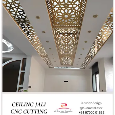 This luxurious ceiling features a long central panel of gold-finished CNC cut jali. The traditional pattern is flanked by simpler jali strips and integrated with cove lighting, turning the entire ceiling into a grand, decorative element.