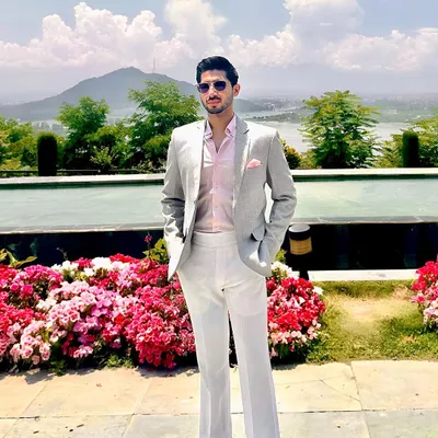 Our client Mr. Anand looking amazingly dapper in our creation. He wears a custom light grey blazer, pink shirt, and white trousers for a perfect summer formal look.