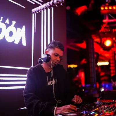 Deep in concentration, lining up the next track. A professional shot of me at the console with my name lit up on the screen behind me.