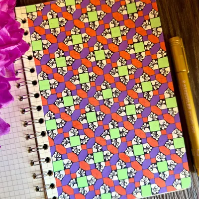 A page from my art journal, filled with a vibrant geometric pattern. The combination of purple, orange, and lime green creates a playful and energetic design. This is truly my kind of therapy.
