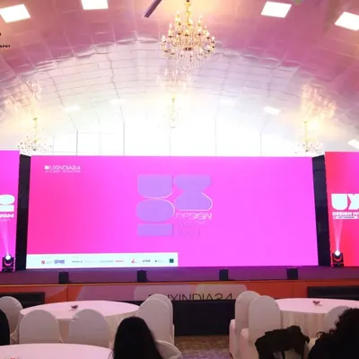 This image showcases the impressive stage and lighting setup for the UXINDIA 2024 summit before the audience arrives, highlighting our attention to capturing the professional ambiance of the venue.