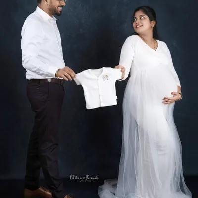 A tiny outfit for a tiny human on the way. Using baby clothes as props is a sweet and classic way to announce your excitement.
