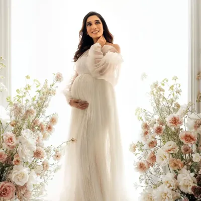 A dreamy, angelic portrait. Framed by delicate flowers and bathed in soft light, this mama to be looks absolutely radiant in a flowing white gown from my studio wardrobe.