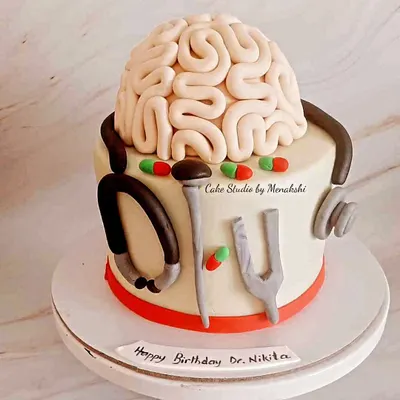 A cake for a neurosurgeon. This unique design features an edible brain, a stethoscope, and other tools of the trade, all handcrafted with care.