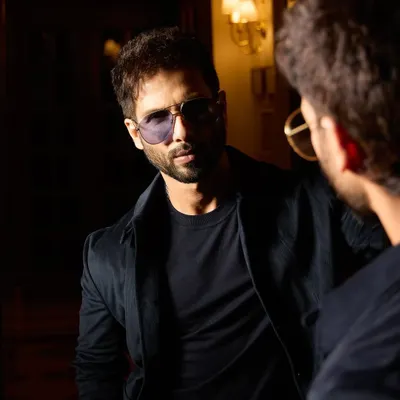 Shahid Kapoor looking sharp as ever for his 'DEVA' promotions. This custom all-black look from Raamz Label, seen here in a moody reflection, is the definition of sleek.