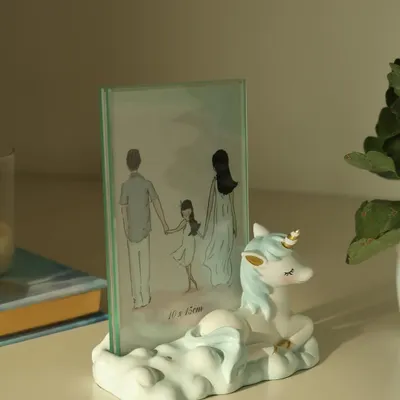 Elevate your child’s space with this whimsical unicorn photo frame. With its pastel tones and dreamy cloud base, it’s the perfect way to preserve a precious moment.