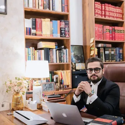 At my desk, where I spend countless hours developing legal strategies and reviewing case files. A well-organized and resourceful office is essential for effective legal practice. This image marks six years of building my firm.